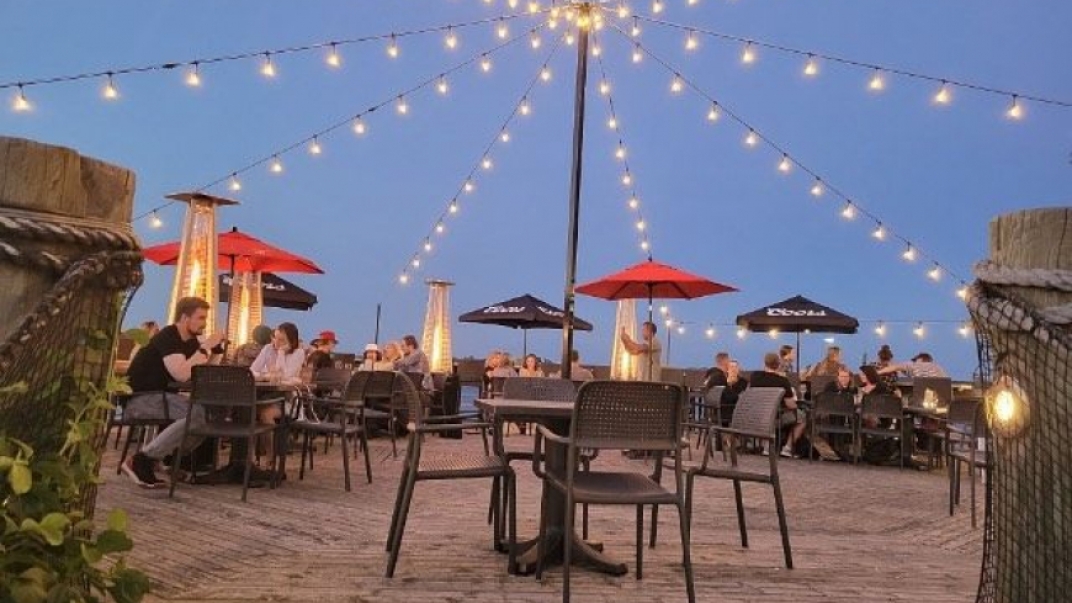 outdoor patio with string lights and red umbrellas