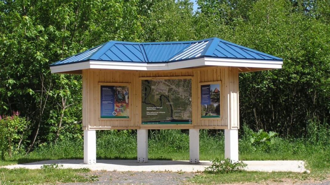 Information booth with park map in middle of park trail