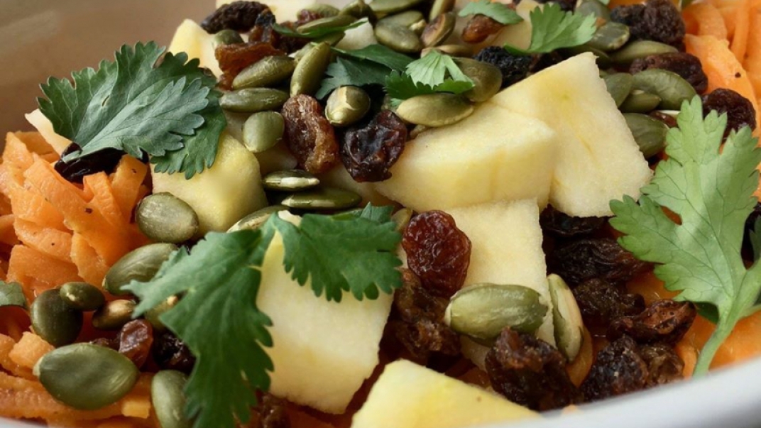 salad with cilantro, nuts, fruit and carrots