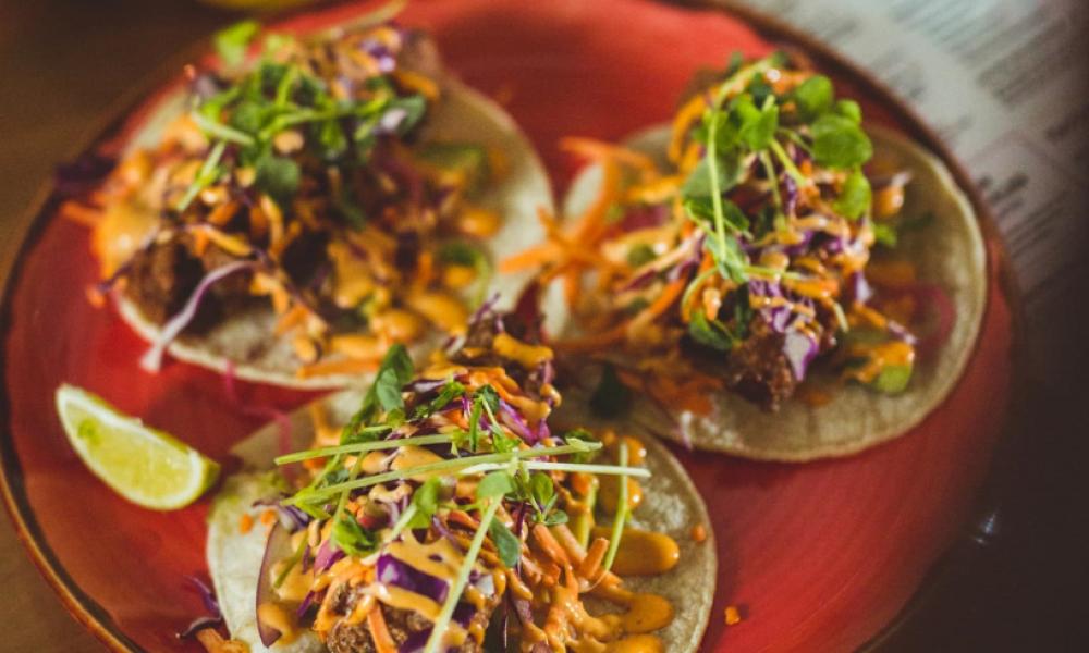 red plate with three tacos