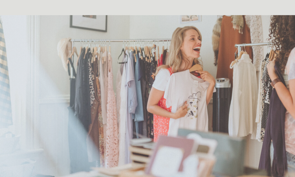 Two women shopping and laughing in a store