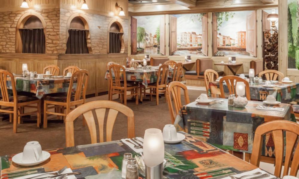 restaurant interior with wooden chairs and brick walls