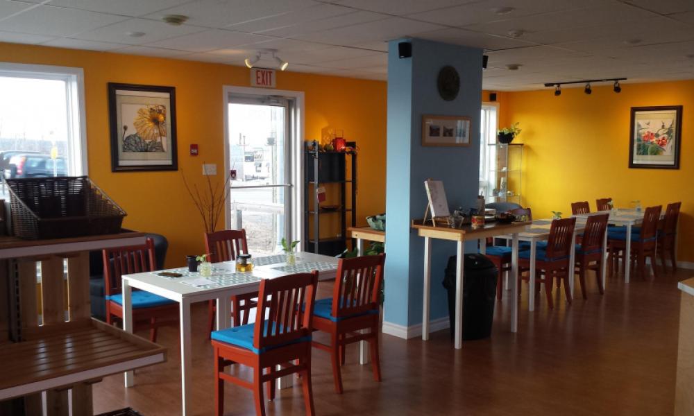 Inside of Lotus restaurant with yellow and blue walls with tables and chairs set up