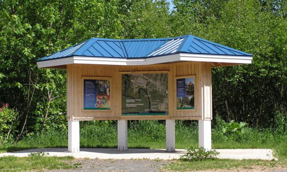 Information booth with park map in middle of park trail