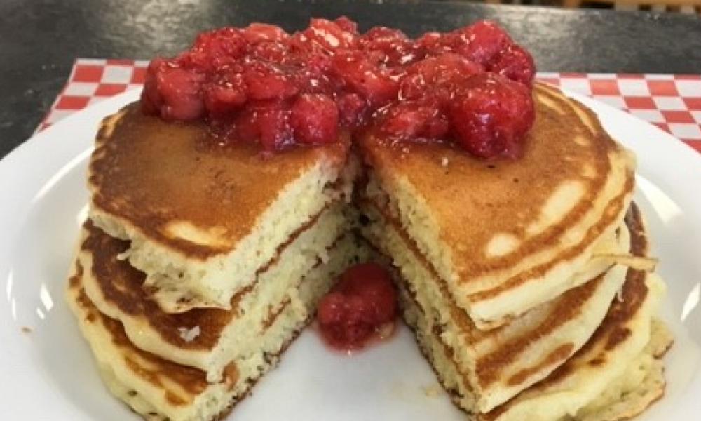 stack of pancakes with berries on top