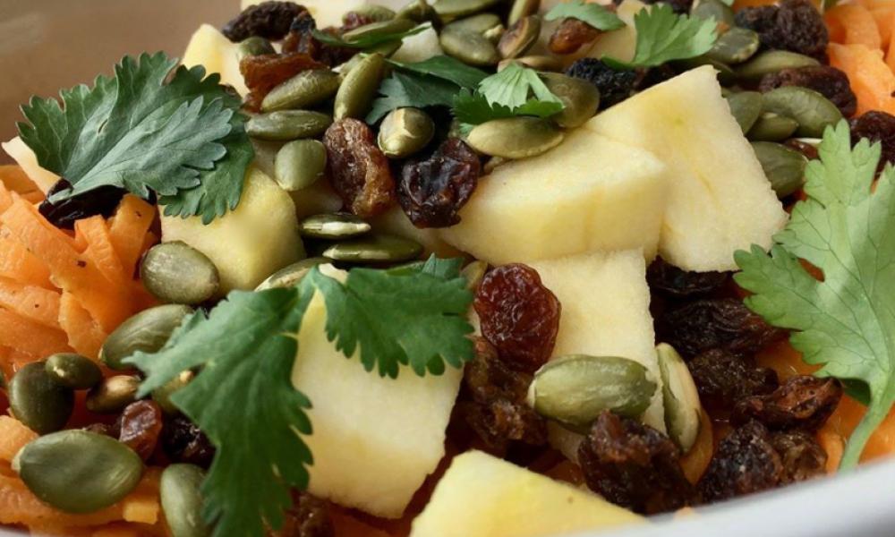 salad with cilantro, nuts, fruit and carrots