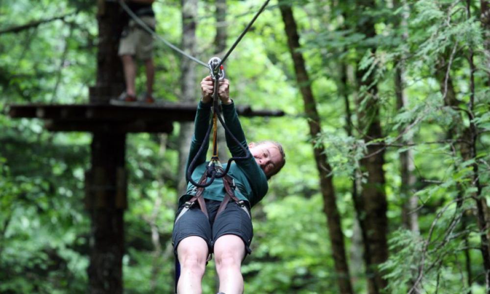 Person on zipline in forest